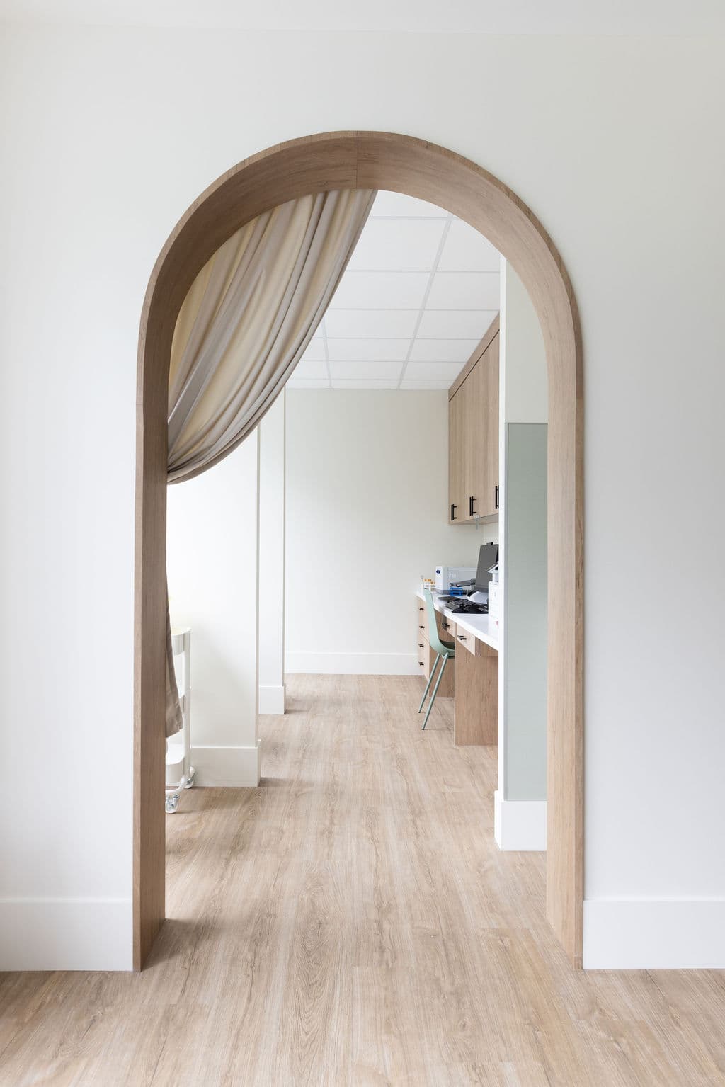 A wood archway leading into a calm Twig clinical area.