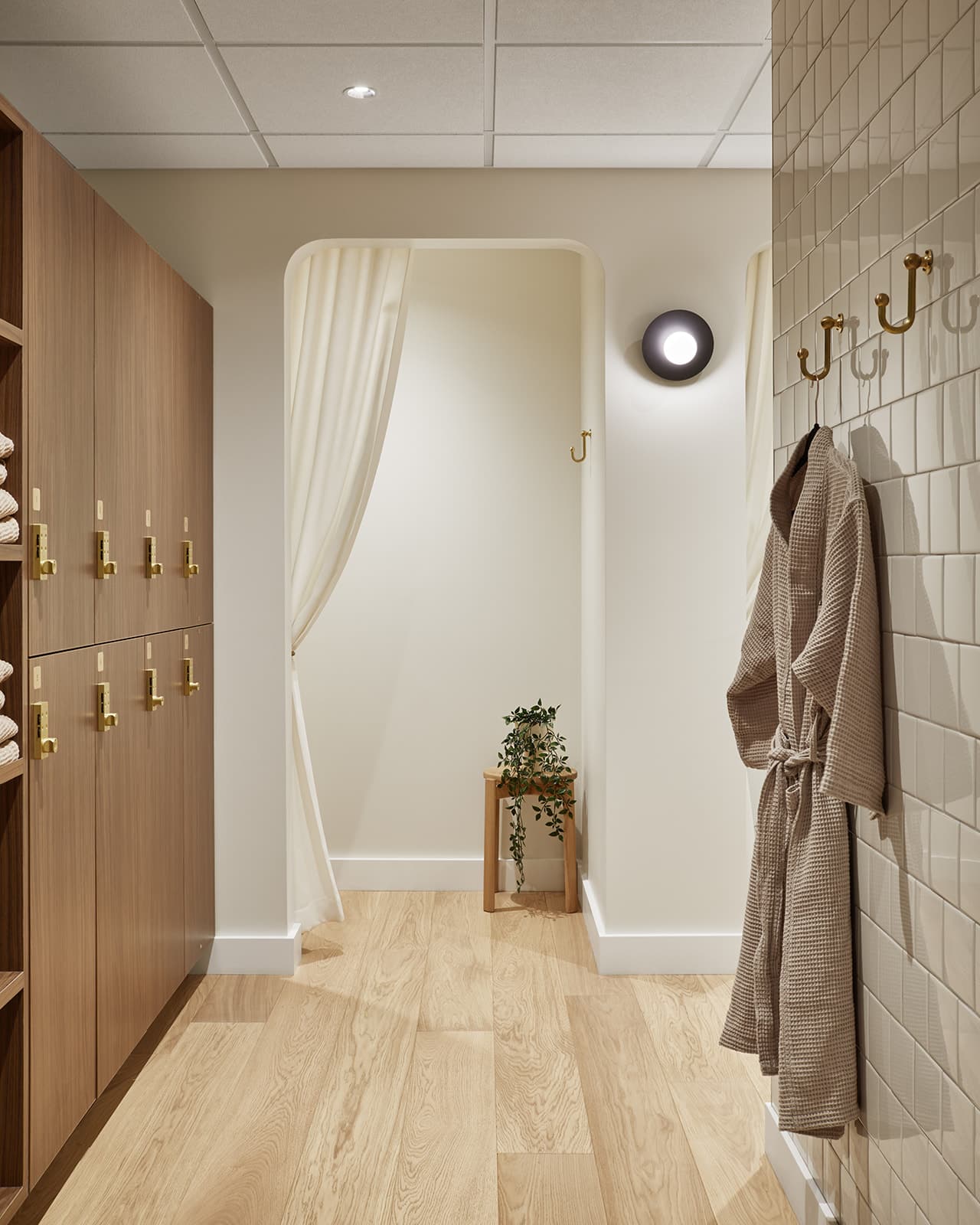 The Midtown changeroom at Twig, with a robe hanging and warm light.